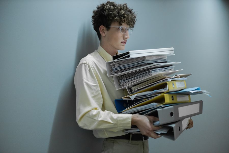 Logistics professional holding a pile of shipping documents